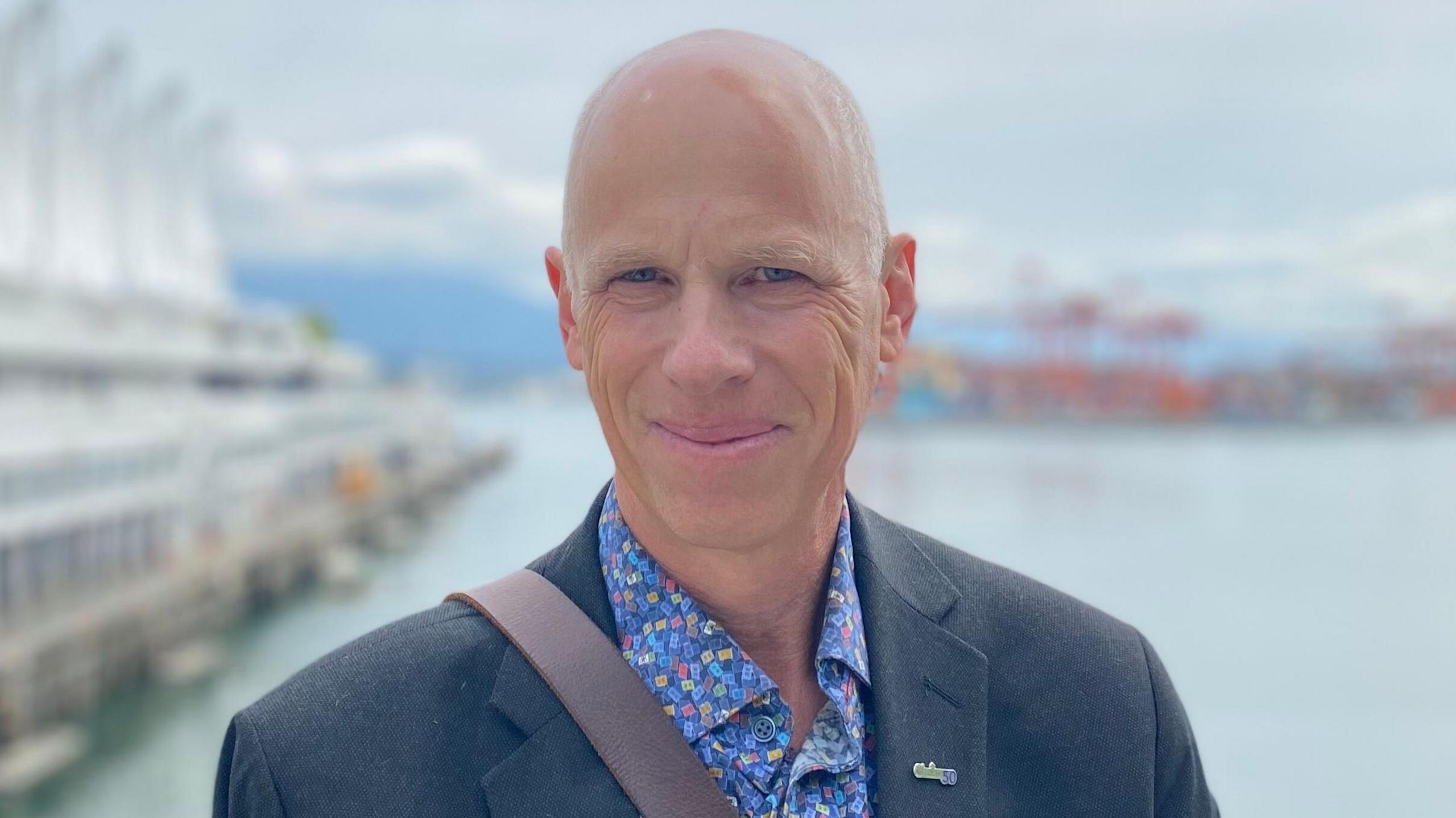 Eric Beckwitt in a blue jacket and blue, patterned shirt