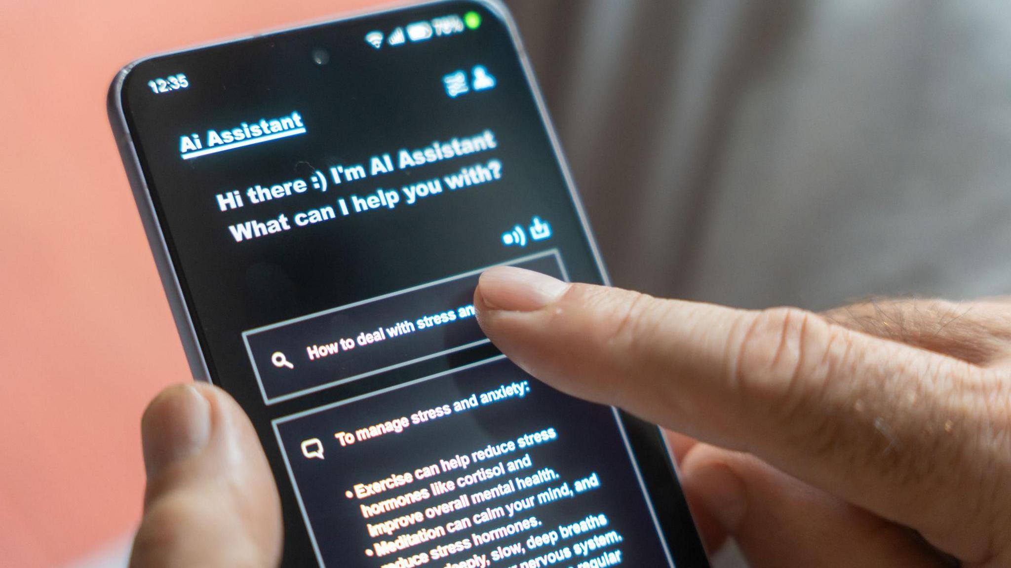 A phone in dark mode and it says at the top "AI assistant. Hi there :) I'm AI Assistant What can I help you with?". There is then a finger pressing a box reading "How to deal with stress". There is then a reply box including avdice to exercise and meditate.